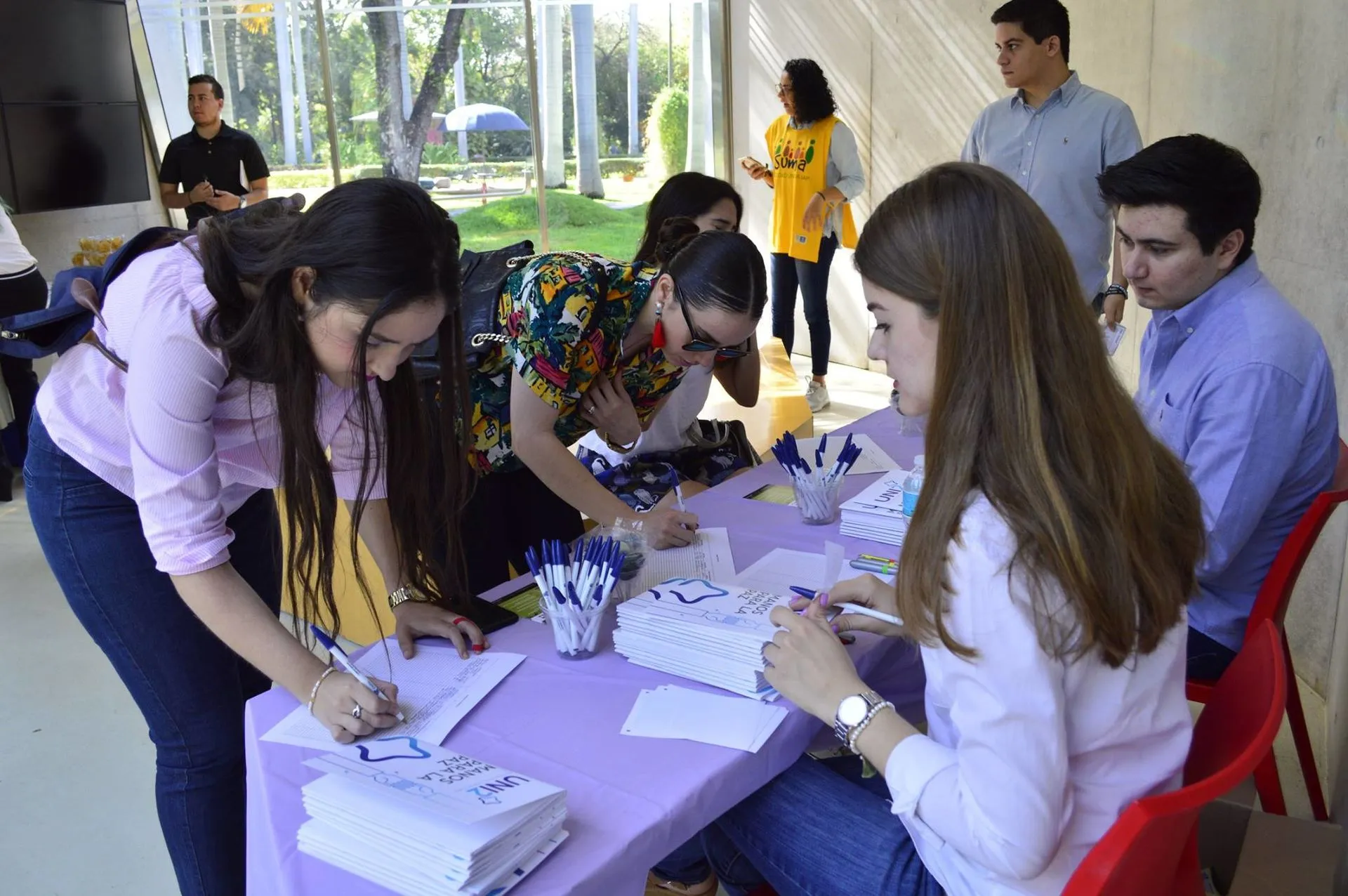 Jovenes registrandose para conferencia de UNI2