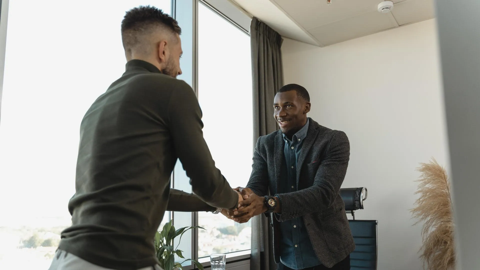 dos personas cerrando una entrevista laboral