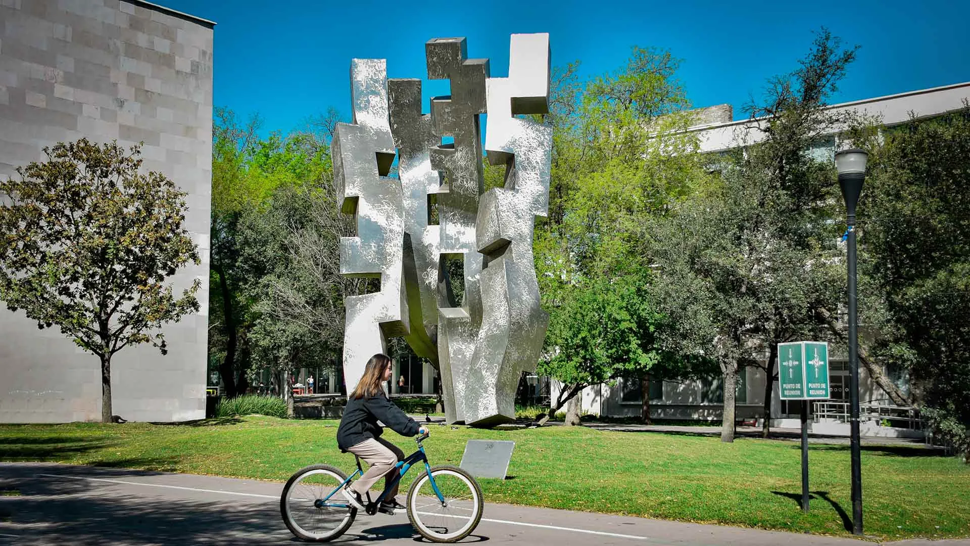 Estudiante del Tec, campus Monterrey, transportándose en bicicleta dentro del campus