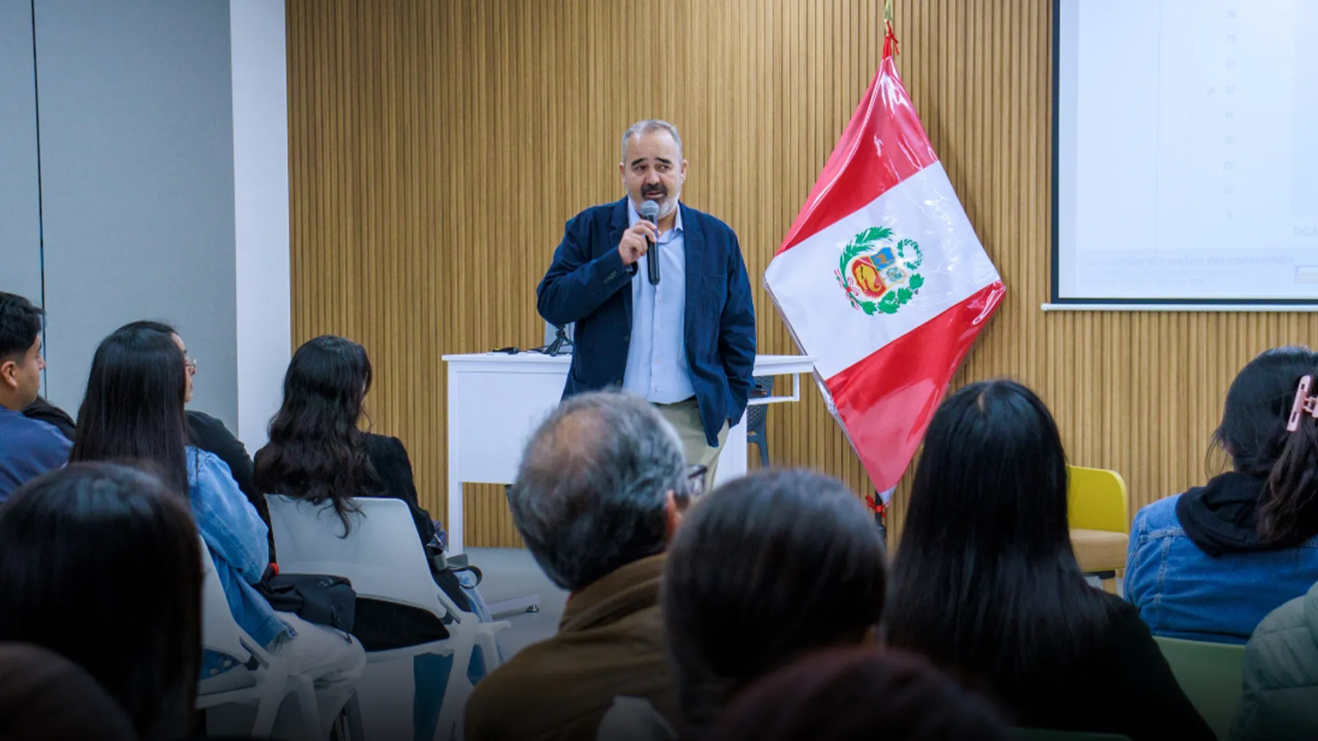 Professor speaking in front of an audience.