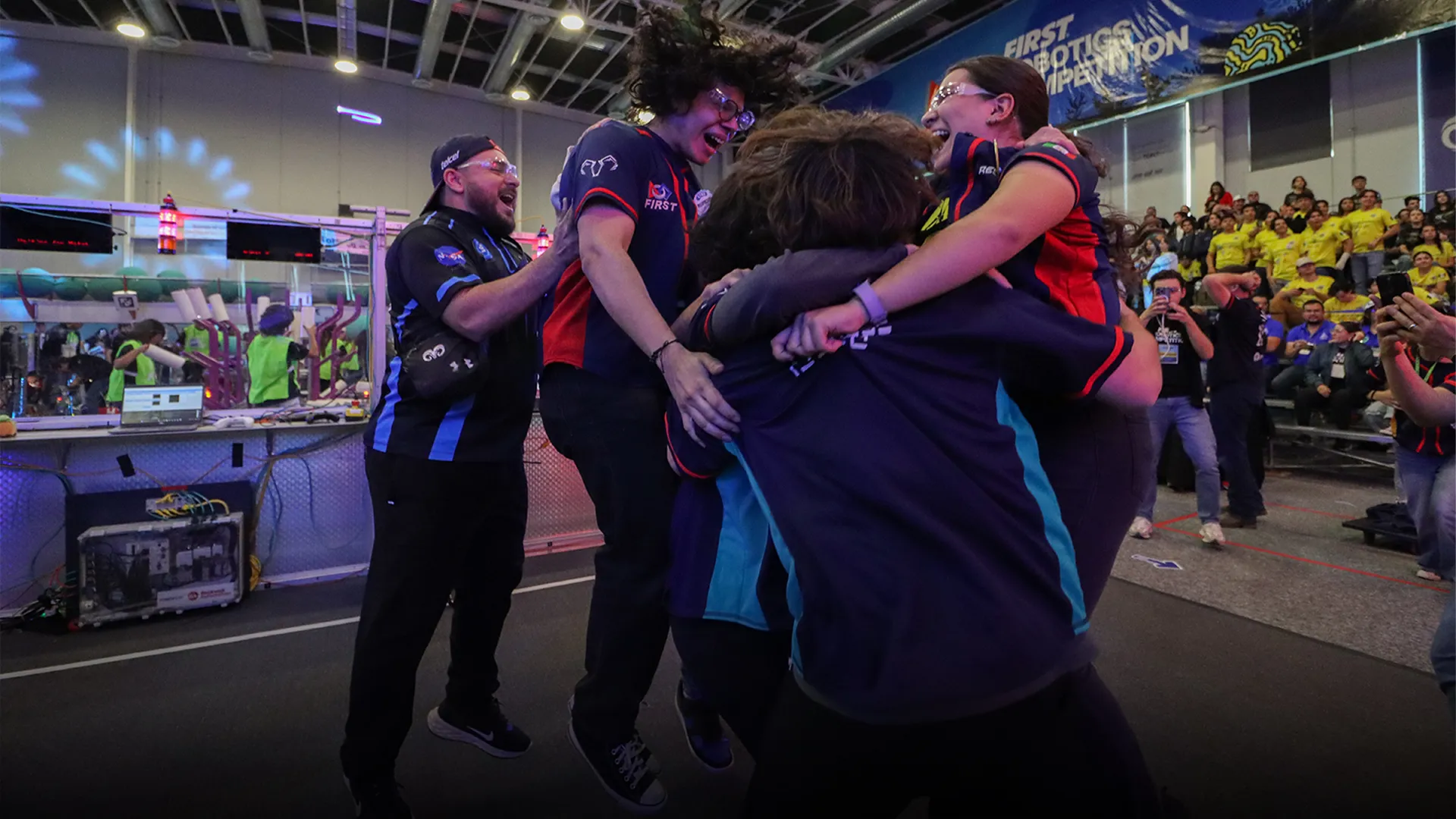 Equipo salta y se abaraza en un momento de celebración. 