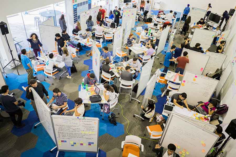 Diversos estudiantes del Tec de Monterrey resolviendo reto en clase