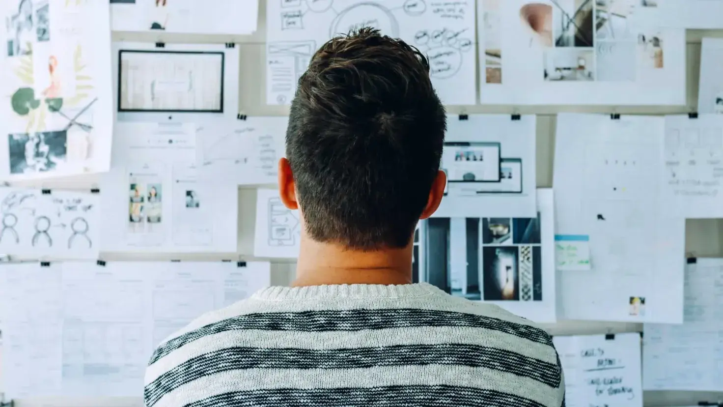 Joven ante un muro de diagramas y planeación